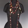 Two long necklaces, old African red/white heart beads and lots of charms