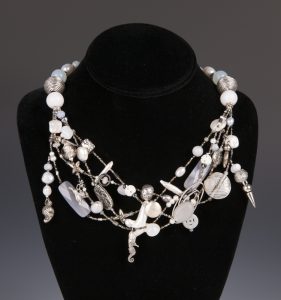 A gorgeous multi-strand necklace with semiprecious gemstones and a variety of charms