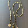 Stunning green kyanite necklace with bronze charms.  About 38 inches long and can be worn as single strand or doubled up for a new look.